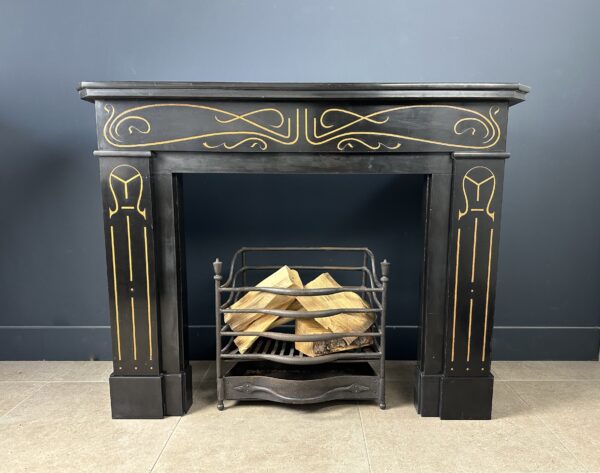 Beautiful antique Etching Fireplace executed in Noir de Mazy black marble. This orbiting fireplace features e Antique fireplace hearth stove marble