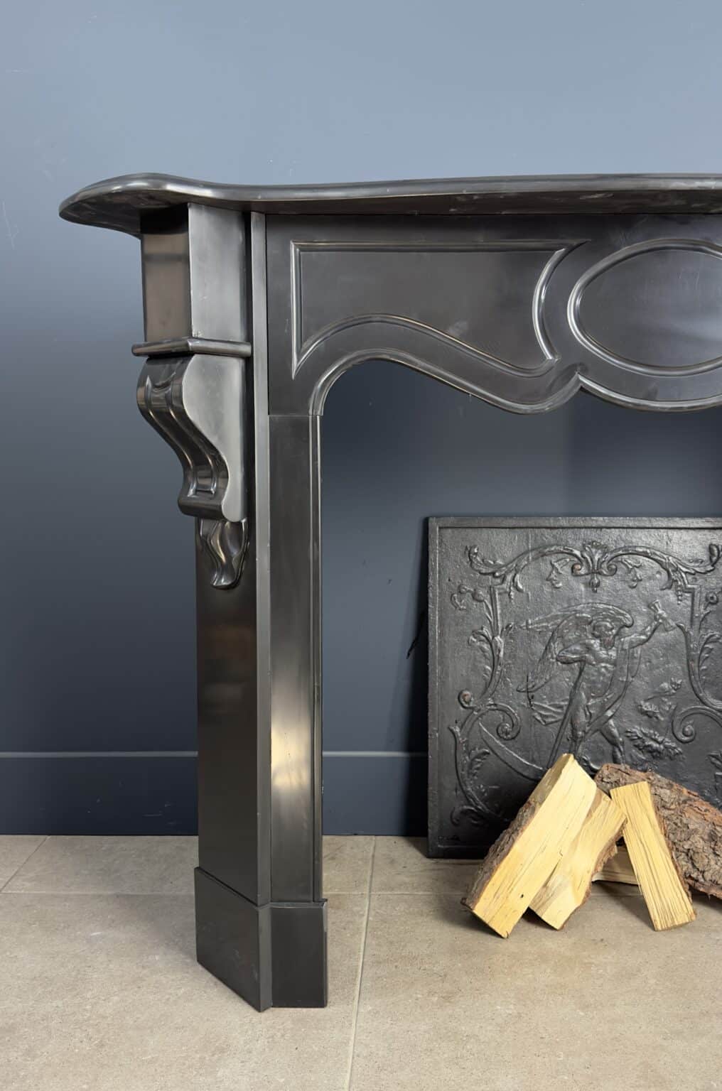Antique Black Marble Fireplace with Angled Consoles — detail 2