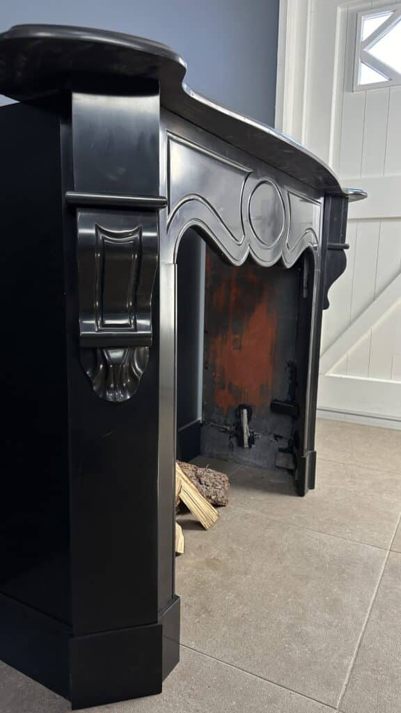 Antique Black Marble Fireplace with Angled Consoles