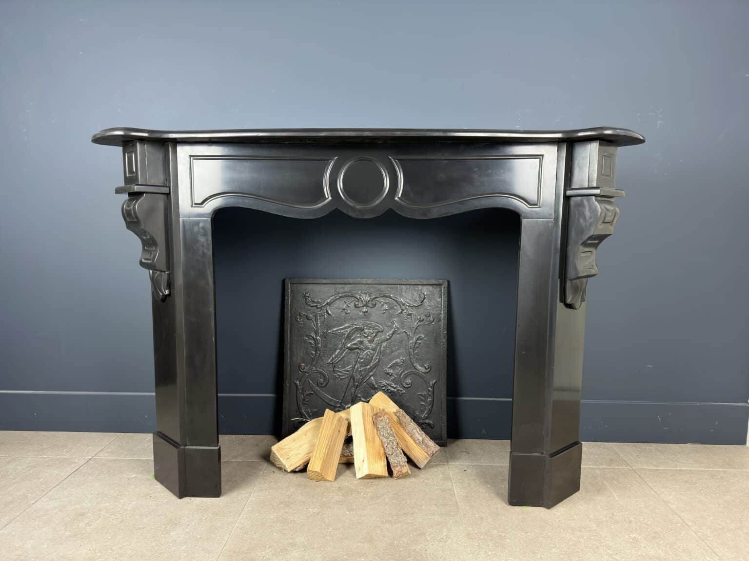 Antique Black Marble Fireplace with Angled Consoles