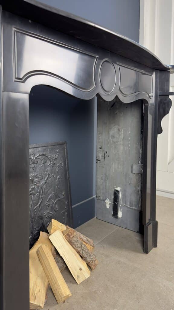 Antique Black Marble Fireplace with Angled Consoles