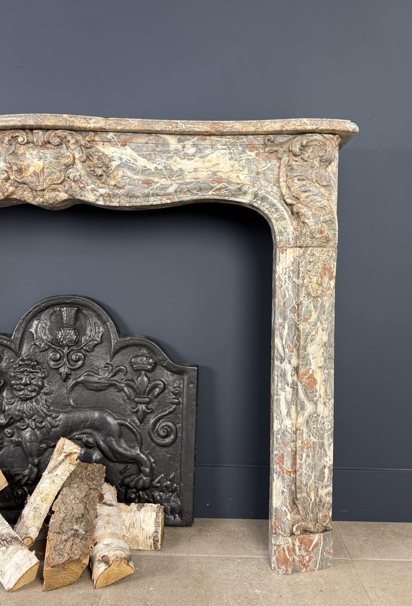 Deze indrukwekkende antieke schouw, afkomstig uit België en vervaardigd rond 1800, is een waar meesterwerk in natuursteen.